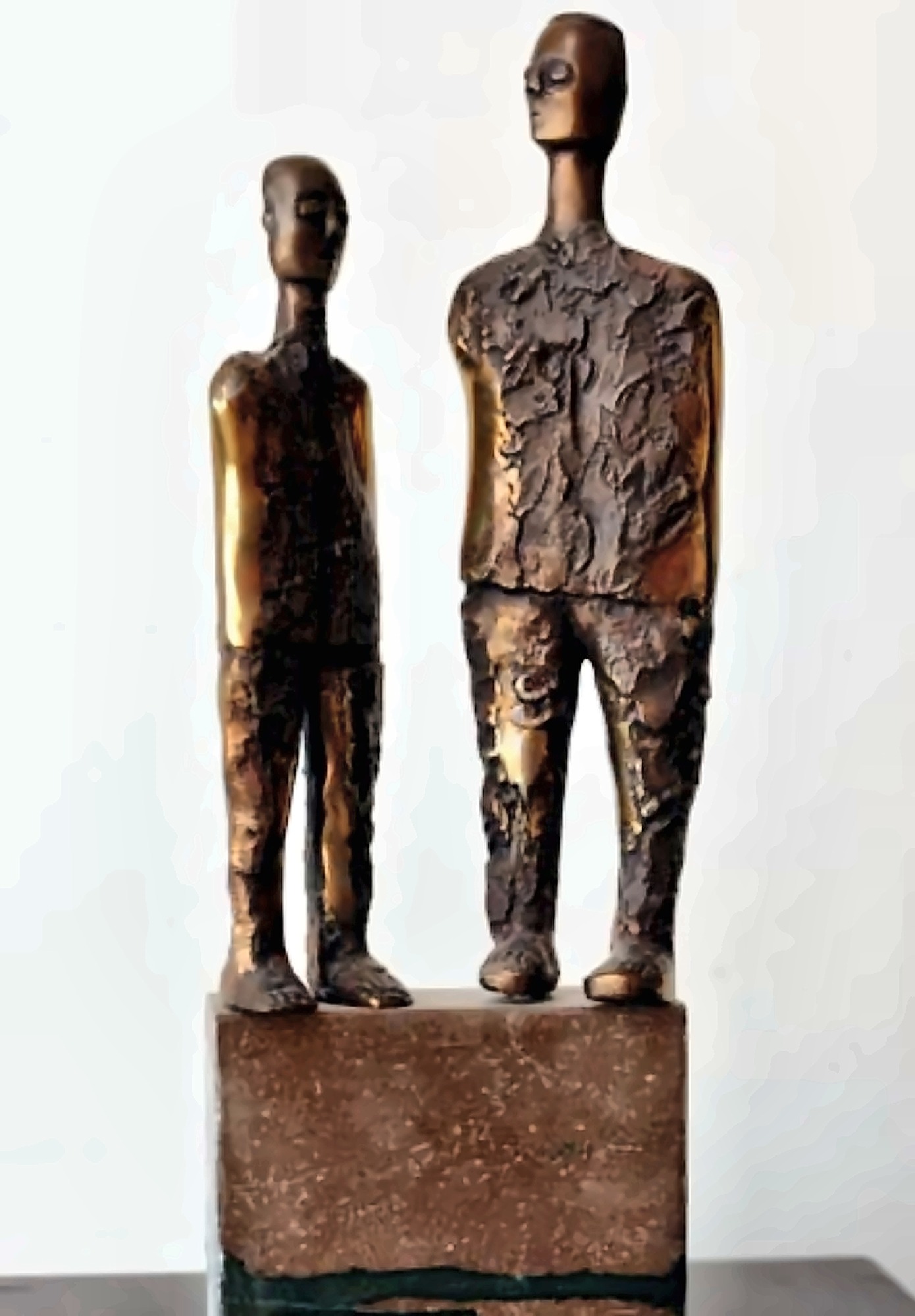 Two standing bronze figures on a shared base.