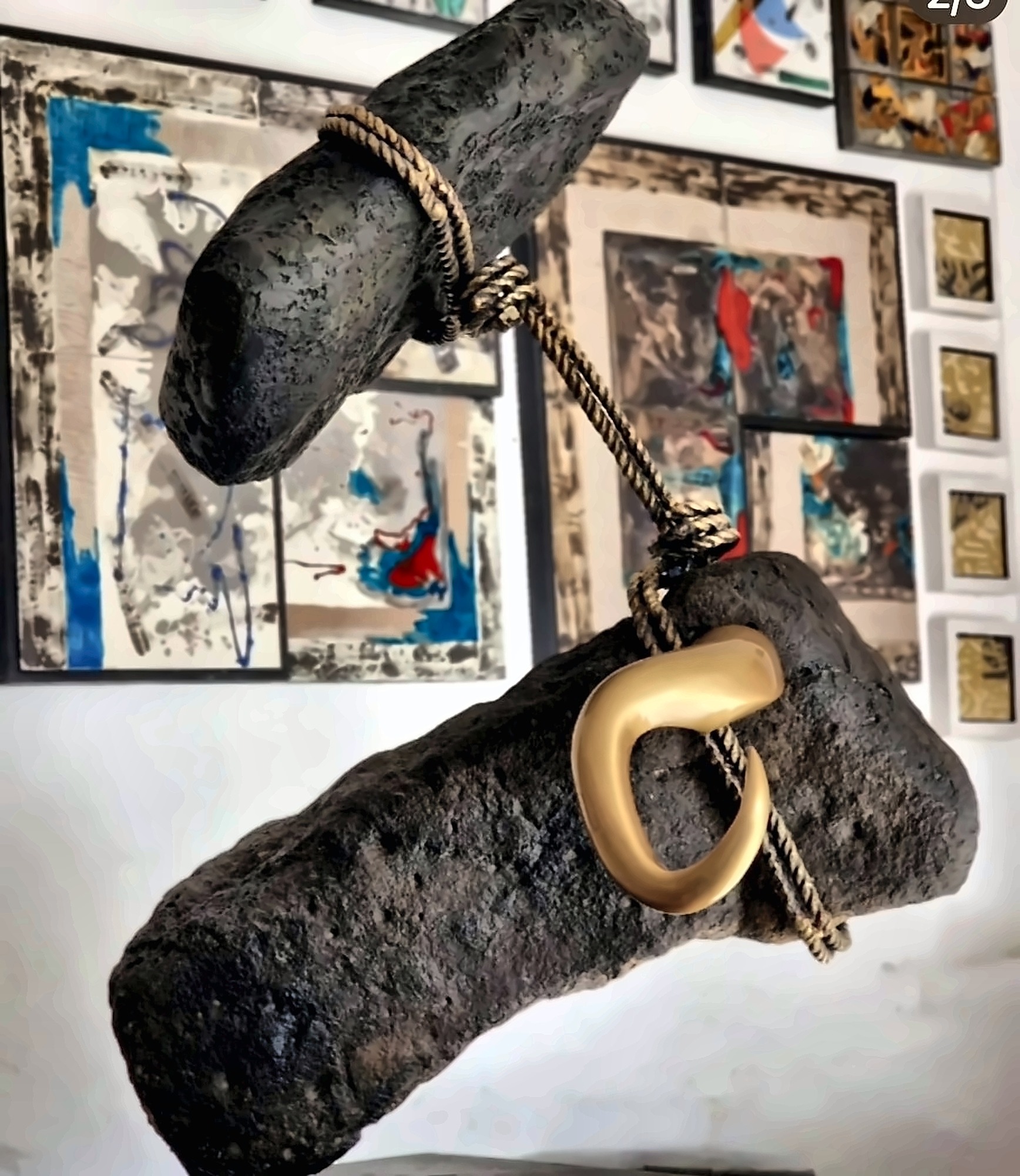 A dark boulder mounted with heavy gilded bronze horns.