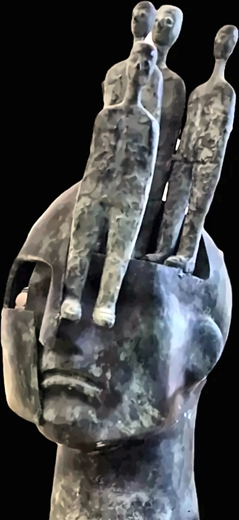 Figures emerging from a sculpted head.