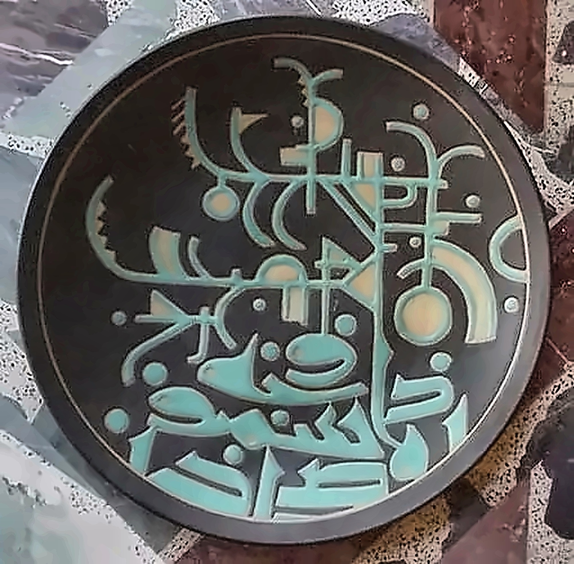 A near-black plate covered edge to edge in pale green incised script and circular signs.
