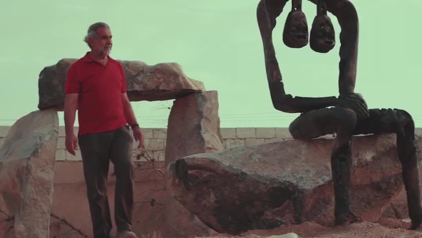 Installing a bronze and stone work outdoors. Amman. Fourteen seconds, silent.